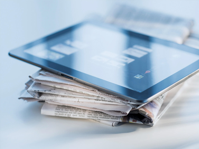 newspapers and a tablet