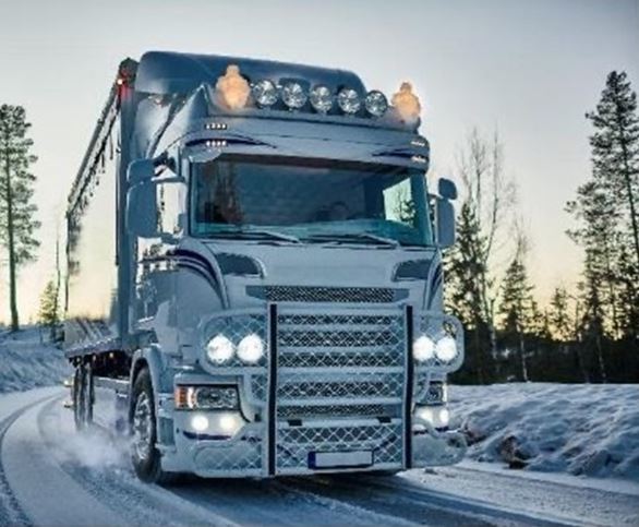 Truck driving through snow