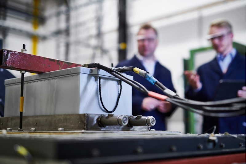 Two Engineers Testing Battery Voltage