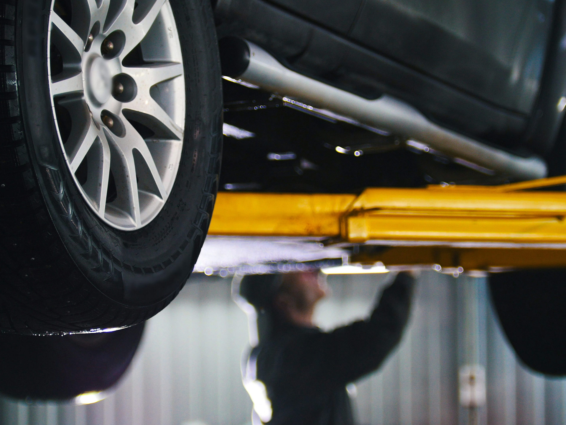 Mechanic working under car