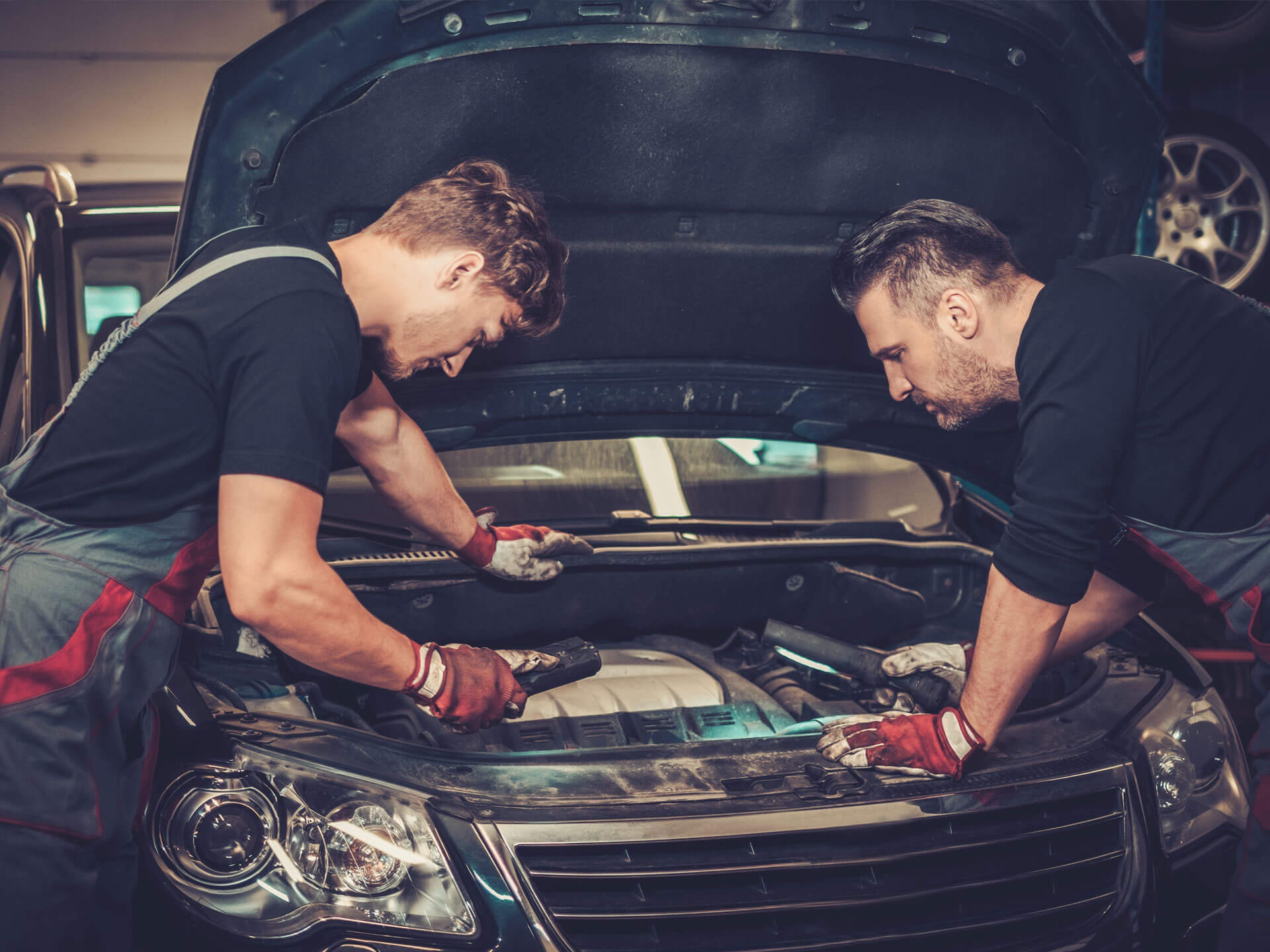 Two men inspecting hood