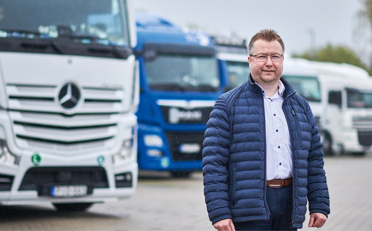 Man in front of trucks