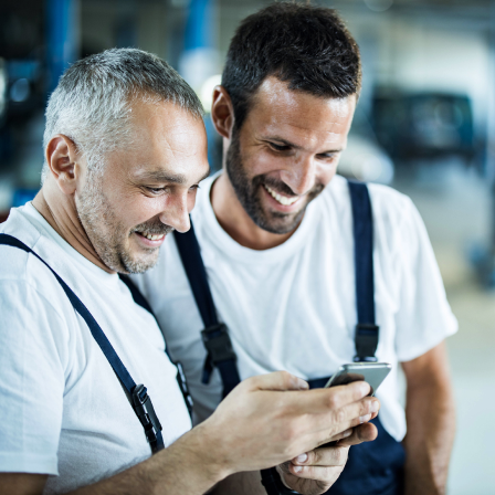 two mechanics on cell phone