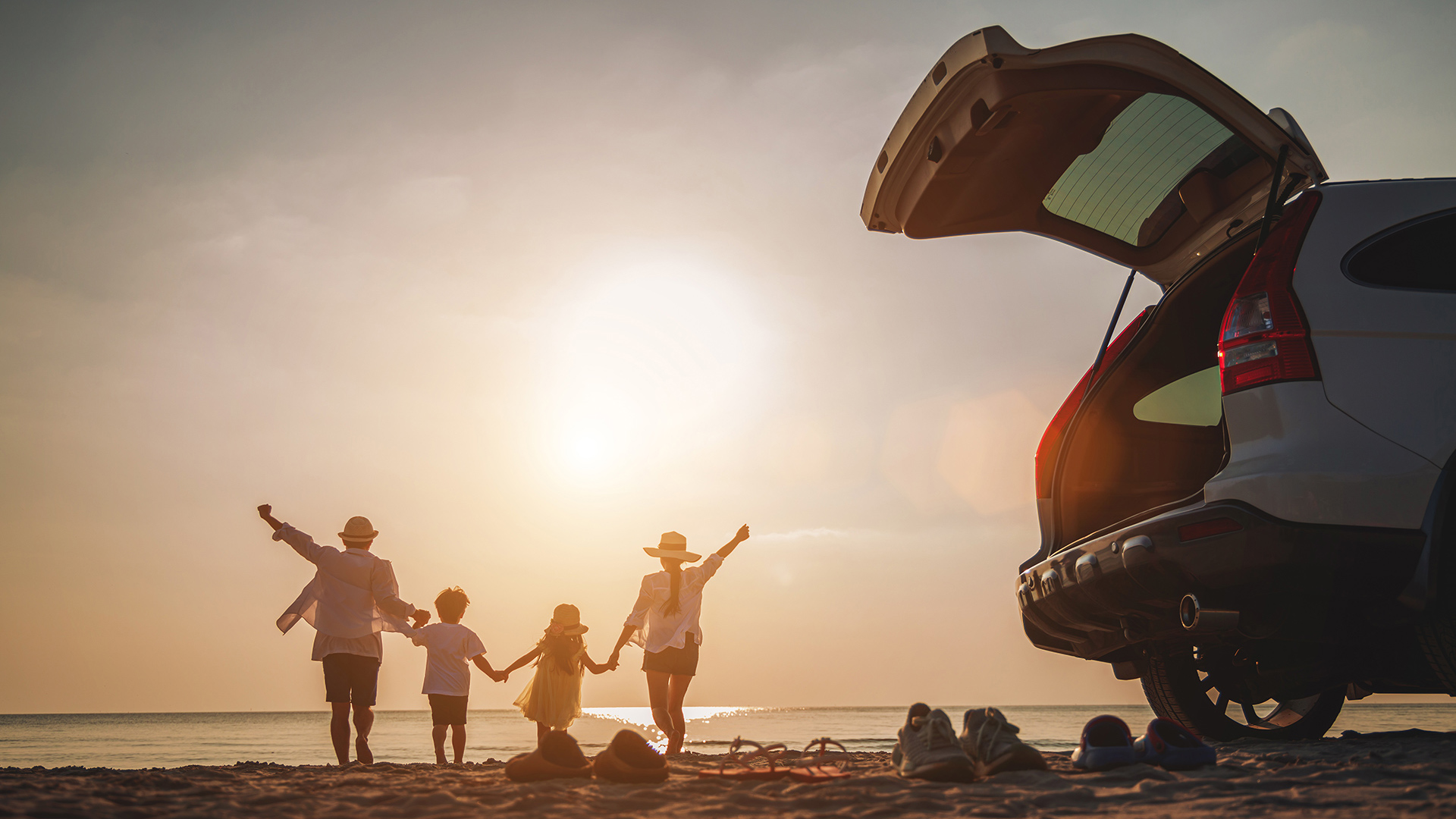 Family at beach, car trunk open